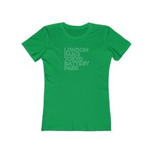 May include: A green t-shirt with the text "LONDON PARIS TOKYO BATTERY PARK" printed in white on the front.