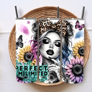 May include: Three cylindrical tumblers with black straws featuring a graphic print of a person with a leopard print bow, sunflowers, butterflies, and pink and blue glitter accents. The text reads I'm not PERFECT I'M LIMITED edition.