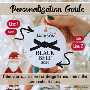 May include: White round ornament with a black belt design and the text "JACKSON BLACK BELT 2024".