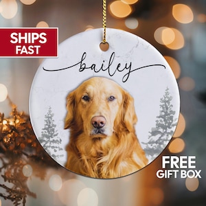 May include: White ceramic Christmas ornament with a marbleized background. The ornament features a golden retriever dog with the name "bailey" written in cursive above the dog.