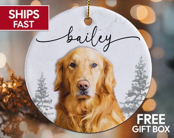 May include: White ceramic Christmas ornament with a marbleized background. The ornament features a golden retriever dog with the name "bailey" written in cursive above the dog.