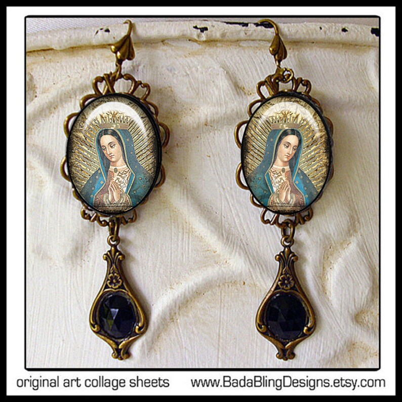 May include: A pair of gold-tone earrings with a black stone dangle. The top of each earring features a round image of the Virgin Mary in a blue robe with a gold crown.