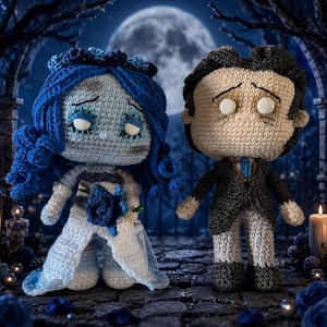 May include: Two amigurumi dolls representing a bride and groom. The bride has blue hair, a blue floral crown, and a white dress with a blue rose. The groom has dark hair, a grey suit, and a blue tie. Both dolls feature white button eyes.