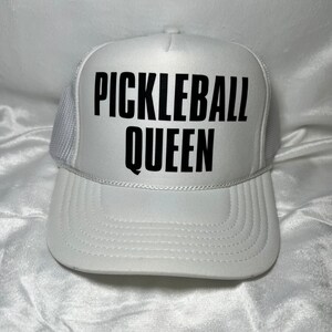 May include: White mesh trucker hat with black text that reads "Pickleball Queen".