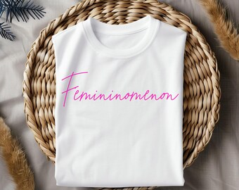 May include: White t-shirt with the word "Feminomenon" written in pink cursive.