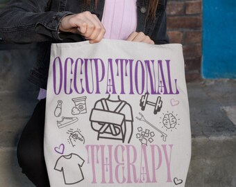 May include: White canvas tote bag with the text "Occupational Therapy" in purple and pink lettering. The bag is decorated with black and white illustrations of common occupational therapy tools and activities, including a brain, a dumbbell, a splint, and a pair of scissors.