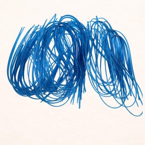 May include: A collection of bright blue, flexible tubes, arranged in a loose, intertwined pattern. The tubes are semi-transparent, allowing light to pass through. The background is a plain, off-white color, providing contrast to the vibrant blue.