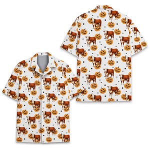 May include: A short-sleeved button-down shirt with a white background featuring an all-over print of brown and white cows interspersed with orange jack-o'-lantern pumpkins and small black stars. The shirt has a notched collar and a front button closure.