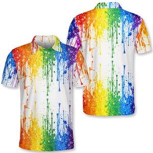 May include: White polo shirt with a colourful rainbow splatter design. The shirt has a classic collar and short sleeves. The paint-like design includes red, orange, yellow, green, blue, and purple hues, creating a bold and artistic look.