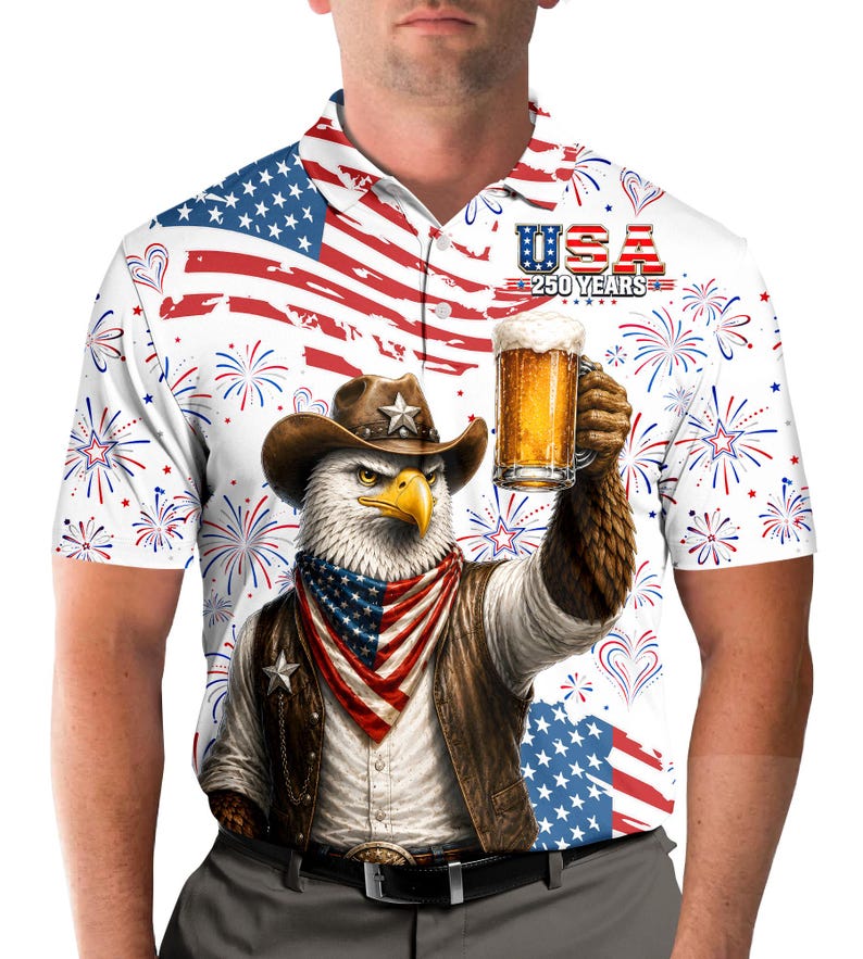 Peut inclure: Polo blanc avec un motif patriotique repr&eacute;sentant un aigle portant un chapeau de cowboy, tenant une chope de bi&egrave;re. Le t-shirt porte un motif USA 250 YEARS, un drapeau am&eacute;ricain et des feux d'artifice.