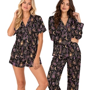 May include: Two-piece pajama sets featuring a black fabric with a repeating print of purple flowers, golden keys, lanterns, crescent moons, and tarot cards. One set includes a short-sleeve button-down shirt and shorts, while the other has a long-sleeve button-down shirt and long pants, all with purple piping.