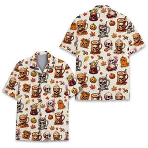 May include: A short-sleeved button-down shirt with an off-white base featuring an all-over print of skulls, jack-o'-lanterns, mugs of hot beverages with whipped cream, autumn leaves, and acorns in shades of orange, brown, and cream.