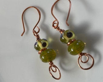 Handcrafted earrings in green and blue lampwork beads and copper ear wires
