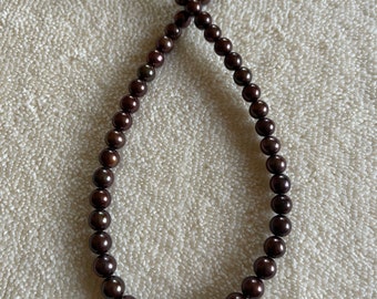 String of NFW pearls. 15 inches long. Beads are 7mm. Rich in color red brown and golds. Smoke and pet free studio