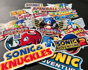 May include: A collection of colorful Sonic the Hedgehog video game stickers. The stickers feature various characters and logos from the Sonic franchise, including Sonic, Knuckles, Tails, and Dr. Eggman. The stickers are perfect for decorating laptops, water bottles, and other personal items.