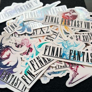 May include: A collection of Final Fantasy stickers featuring various game titles. The stickers have a white background with the game's logo and artwork. The stickers are in various shapes and sizes, with vibrant colors and detailed illustrations.