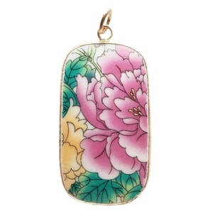 May include: A rectangular pendant with a gold-coloured frame. The pendant features a floral design with pink and yellow flowers, green leaves, and a white background. The pendant has a small loop at the top for a chain.