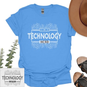 May include: Light blue t-shirt with a white graphic of a circuit board and the text "TECHNOLOGY HCSD".