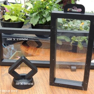 May include: Three black display cases for collectibles. The largest case measures 300 x 110 mm, the medium case measures 196 x 90 mm, and the smallest case measures 50 x 50 mm.