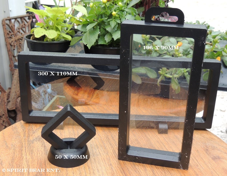 May include: Three black display cases for collectibles. The largest case measures 300 x 110 mm, the medium case measures 196 x 90 mm, and the smallest case measures 50 x 50 mm.