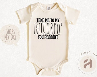 May include: A cream-colored baby onesie with black text that reads "Take me to my Aunt You Peasant".