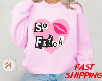 May include: Pink sweatshirt with a pink heart graphic that says "So Fetch" in black letters. The heart graphic also includes a pink lipstick kiss.