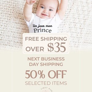 A smiling baby wearing a white onesie with the text "Un jour mon Prince" is lying on a white blanket. The image is promoting a free shipping offer and a 50% discount on selected items.