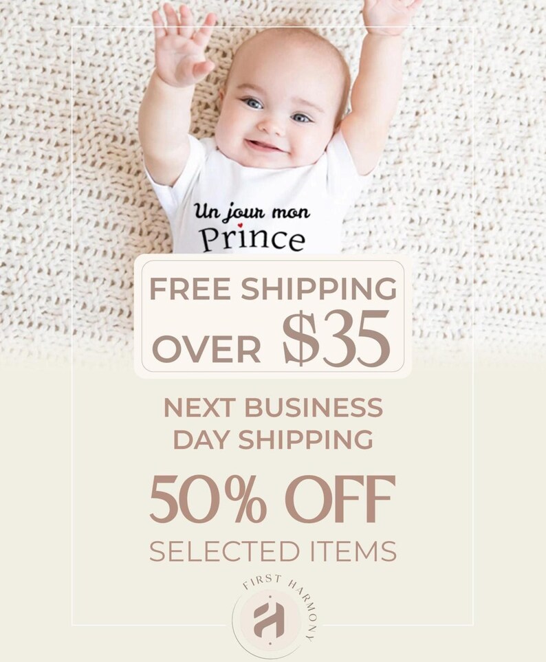 A smiling baby wearing a white onesie with the text "Un jour mon Prince" is lying on a white blanket. The image is promoting a free shipping offer and a 50% discount on selected items.