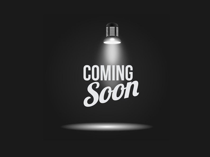 May include: A spotlight shines on a black background with the text "COMING SOON" in white.