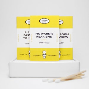 May include: Three yellow cards with black text and a toilet icon. The cards are titled "A Bad Pass to II", "Howard's Rear End", and "Room with a View". The cards are part of a series called "Literary Lites" and are labeled "Suspense" and "Complete" or "Unsanitary".