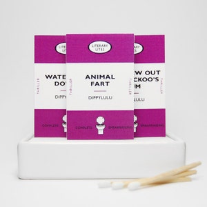 May include: Three pink and white matchbox-sized books with titles "Water Do", "Animal Fart", and "Now Out Cuckoo's Nest". Each book has a small toilet icon and the words "Complete" and "Embarrassing" printed on the bottom.