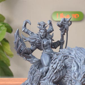 May include: A gray 3D printed figurine of a female orc riding a wolf. The orc is holding a staff with a skull at the top. The figurine is detailed and has a realistic look.
