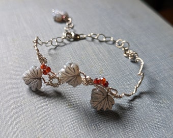 Silver wire and gray Czech leaf Bracelet with garnet gemstones. Twisted wire whimsical woodland bracelet. Adjustable length.