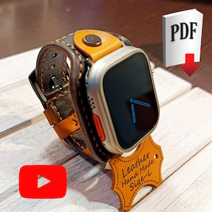 May include: A brown leather watch band with orange stitching and a silver smartwatch face. The watch band is labeled "Leather Hand Made Size - L".