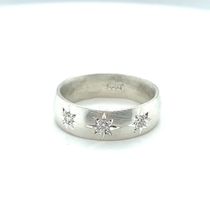 Silver cigar band ring with diamonds and starburst engraving