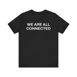 May include: Black t-shirt with the white text "WE ARE ALL CONNECTED" across the chest. The shirt has short sleeves and a crew neck. The fabric appears to be a soft, comfortable material.