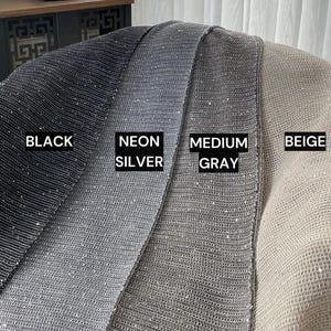 May include: Four fabric swatches in black, silver, grey, and beige. Each swatch has a sparkly, textured surface.