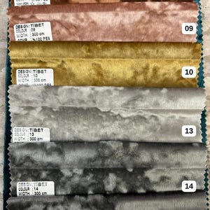 K&ouml;nnte beinhalten: Ein Stoffmuster-Set mit sechs horizontalen Streifen aus Knitter-Samt in Braun, Altrosa, Senfgelb, Hellgrau, Dunkelgrau und Anthrazit. Jeder Streifen hat ein wei&szlig;es Etikett mit Text, darunter DESIGN:TIBET, WIDTH: 300 cm und 100 PES.