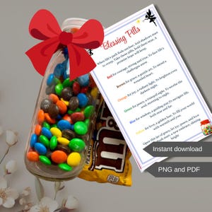 May include: A clear glass jar filled with colorful candies and a red bow. A printed card with the text "Blessing Pills" and inspirational messages is next to the jar. A bag of peanut candies is also visible.