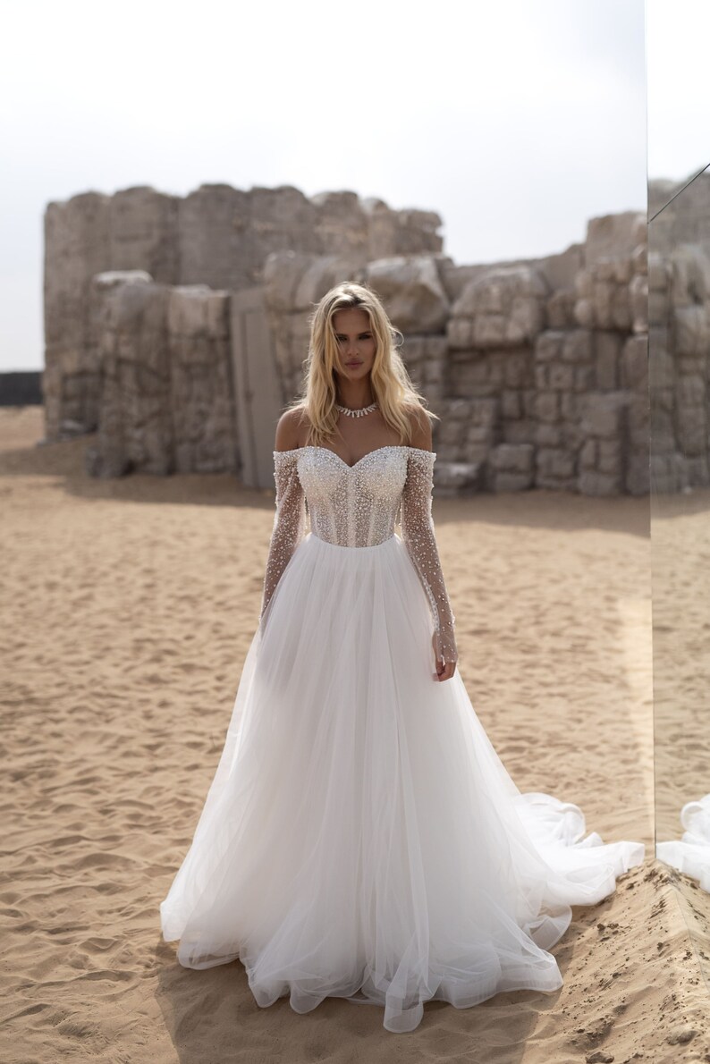 Elegant A-Line Wedding Dress with Halter Neckline, Open Shoulders, and Pearl Embellishments