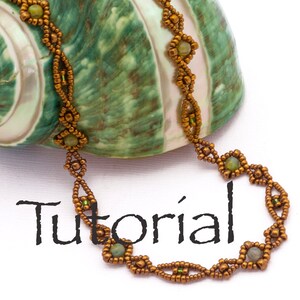 May include: A gold and green beaded necklace with a diamond pattern, resting on a seashell. The necklace is on a white surface with the word "Tutorial" written in black.