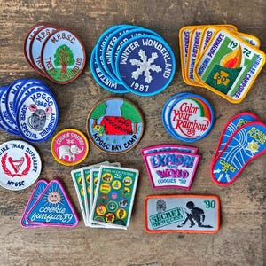 May include: A white ceramic mug with a black handle and the text "But First, Coffee" in a handwritten style. The mug is on a white surface. The mug is 4 inches tall.