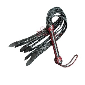 May include: A black and red leather whip with a braided handle and multiple strands. The whip is approximately 30 inches long.