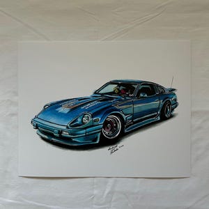 May include: A detailed illustration of a blue sports car with a sleek design. The car features a low profile, rounded headlights, and a spoiler. The artwork is signed in the lower right corner.