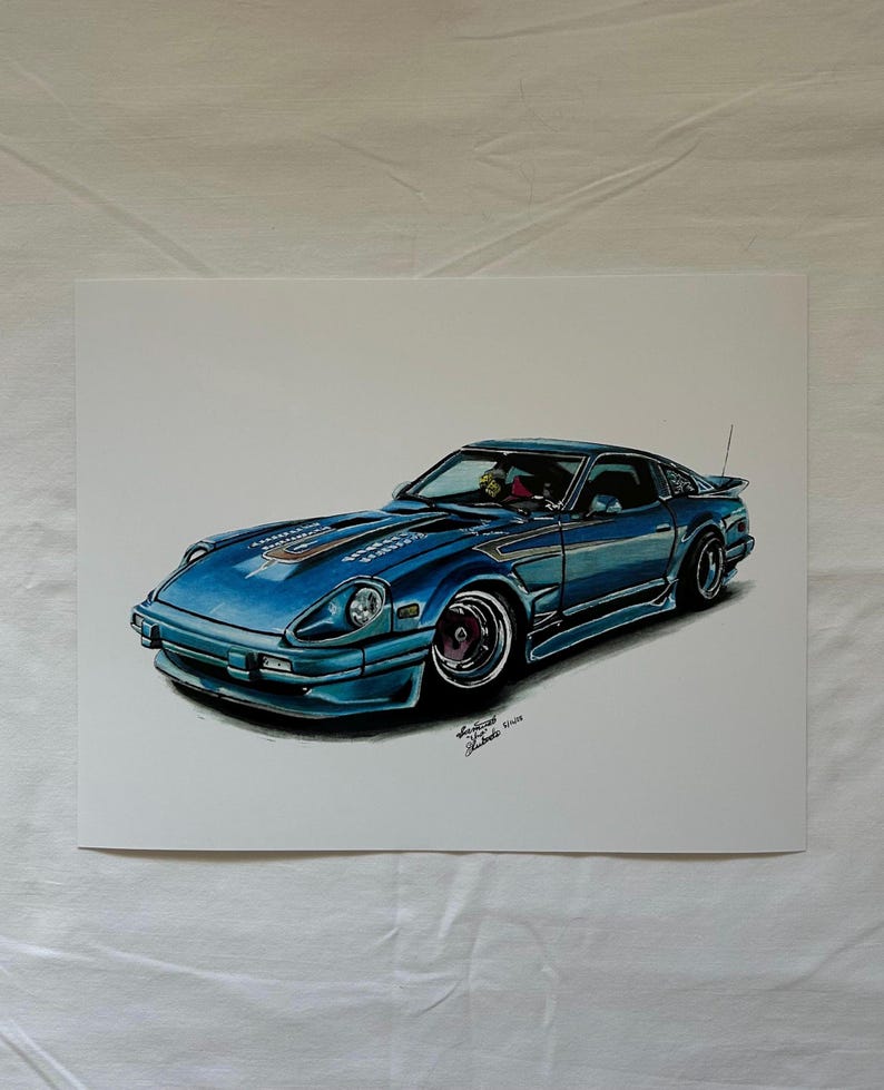 May include: A detailed illustration of a blue sports car with a sleek design. The car features a low profile, rounded headlights, and a spoiler. The artwork is signed in the lower right corner.