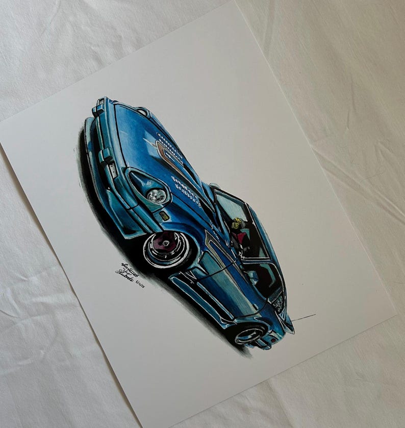 May include: A detailed illustration of a blue sports car with a lowered suspension and custom wheels. The artwork features shading and highlights to give the car a realistic appearance. The car's interior is visible through the open door.