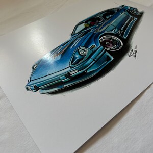 May include: A blue sports car illustration with a low angle perspective. The car is painted in shades of blue with black accents. The artwork includes the artist's signature and date.