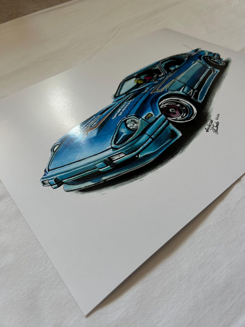 May include: A blue sports car illustration with a low angle perspective. The car is painted in shades of blue with black accents. The artwork includes the artist's signature and date.