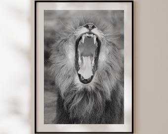 May include: A black and white photograph of a lion with its mouth open wide, showing its teeth and tongue. The lion's mane is thick and full, and its eyes are closed.