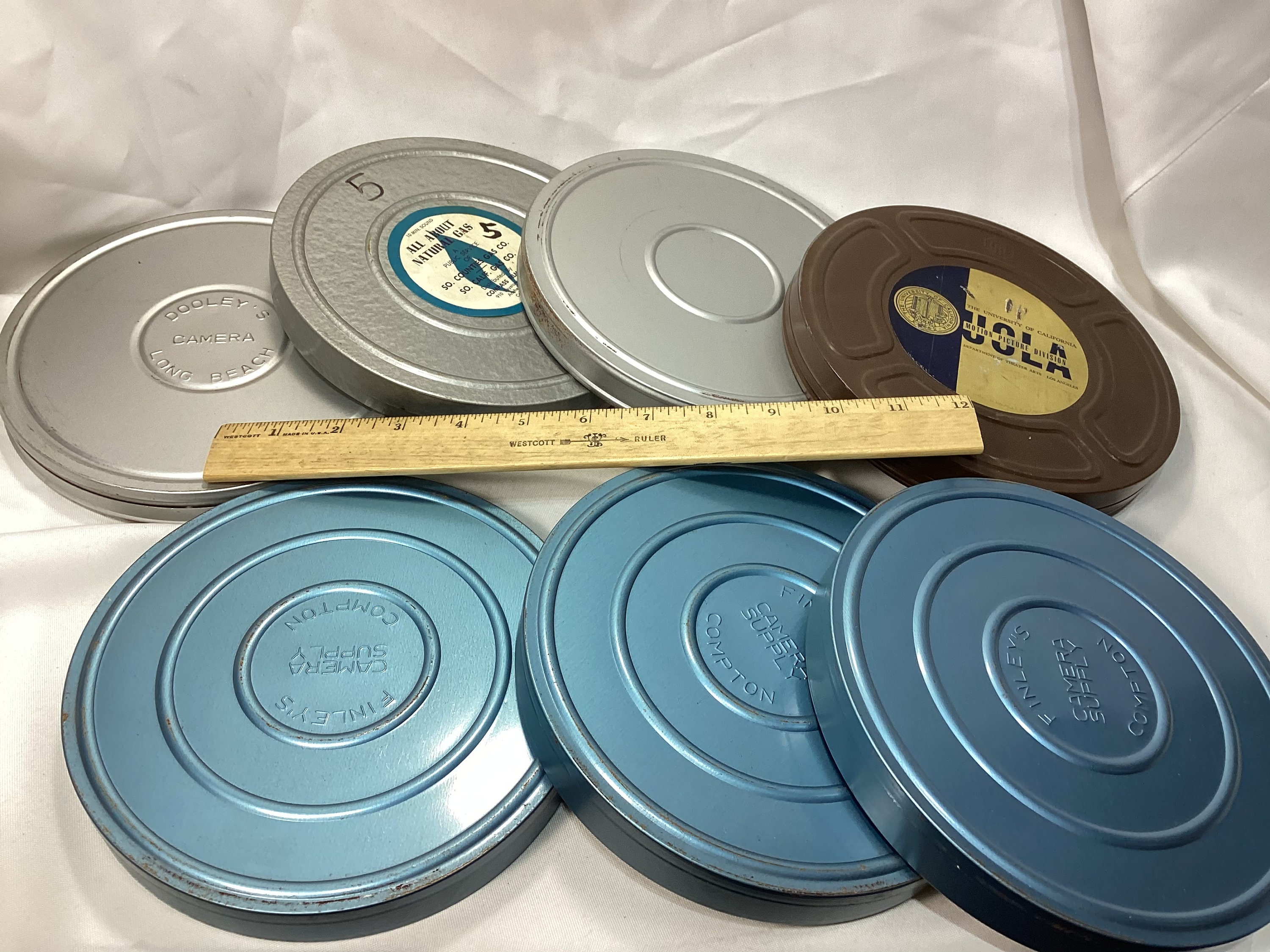 6 film - 8mm reels and metal cases,7 inch,real nice shape,you get all 6,  lot 2